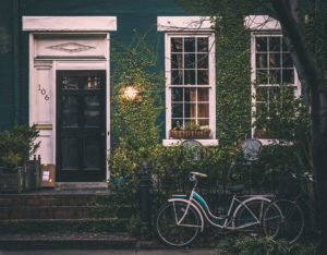 A Black Door Stands Out Against Greenery