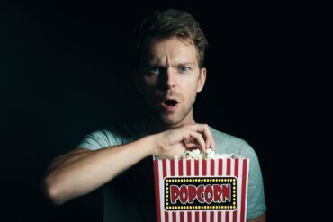 man eating popcorn