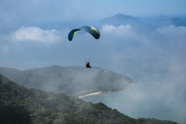 Skydiving Over A Foggy Coast